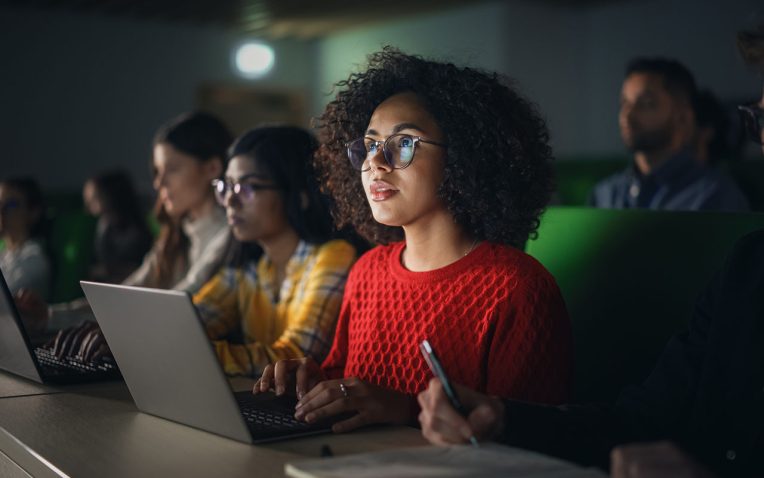 Multi-ethnic students in a classroom listening to a lecture